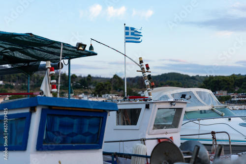 Fishing boat with flag of Greece in harbour