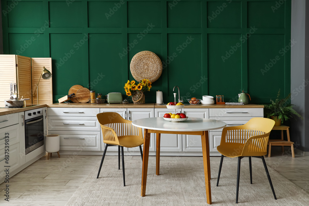 Interior of modern kitchen with white counters and dining table Stock ...