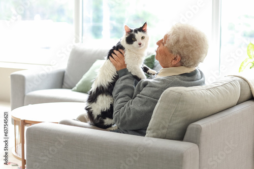 Photography Senior woman with cute cat resting at home