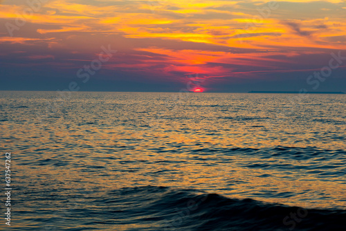 Sunset over the water on a dark background of sunlight over the Mediterranean Sea