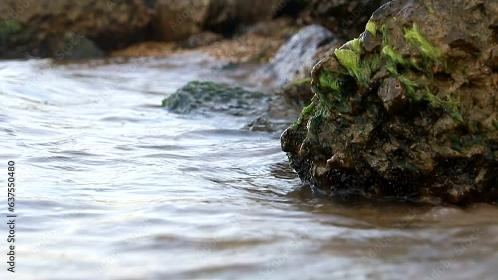 Close-up small waves crashing against the rocks Close-up small waves crashing against the rocks