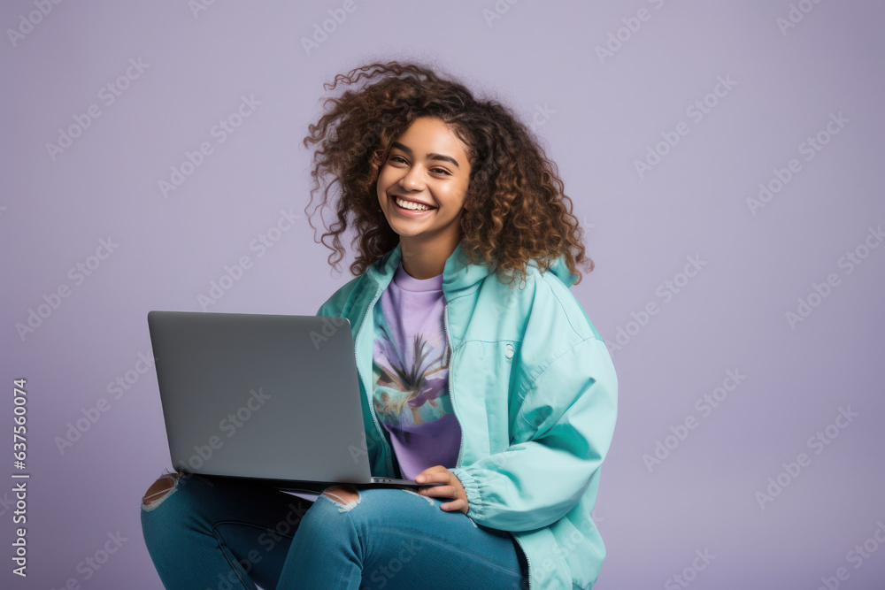Girl is sitting up and smiling while using her computer with laptop Girl is sitting up and smiling while using her computer with laptop
