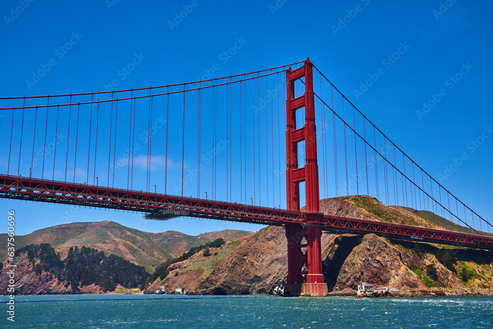 Close up of Golden Gate Bridge with bright summer day with blue skies and choppy bay waters