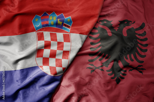big waving national colorful flag of croatia and national flag of albania .