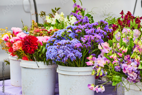 Photography Gorgeous flowers in large white buckets ready for sale