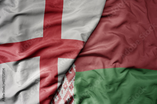 big waving national colorful flag of england and national flag of belarus .