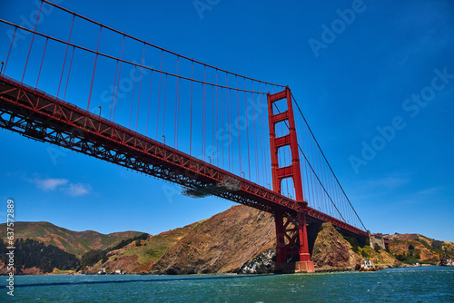 Underside and side view of Golden Gate Bridge with choppy San Francisco Bay waters