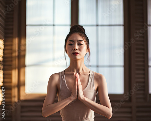 Chinese young woman doing yoga in a yoga studio. Free Download Chinese young woman doing yoga in a yoga studio. - GFXLoad