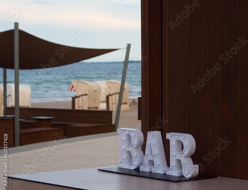 Bar sign by the beach.