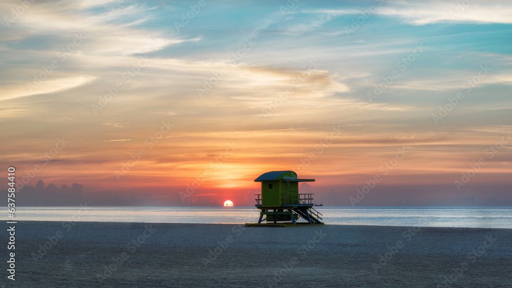 Fototapeta premium Lifeguard tower at Sunrise in Miami Beach, Florida. Vintage processed. Fashion travel and tropical beach concept.