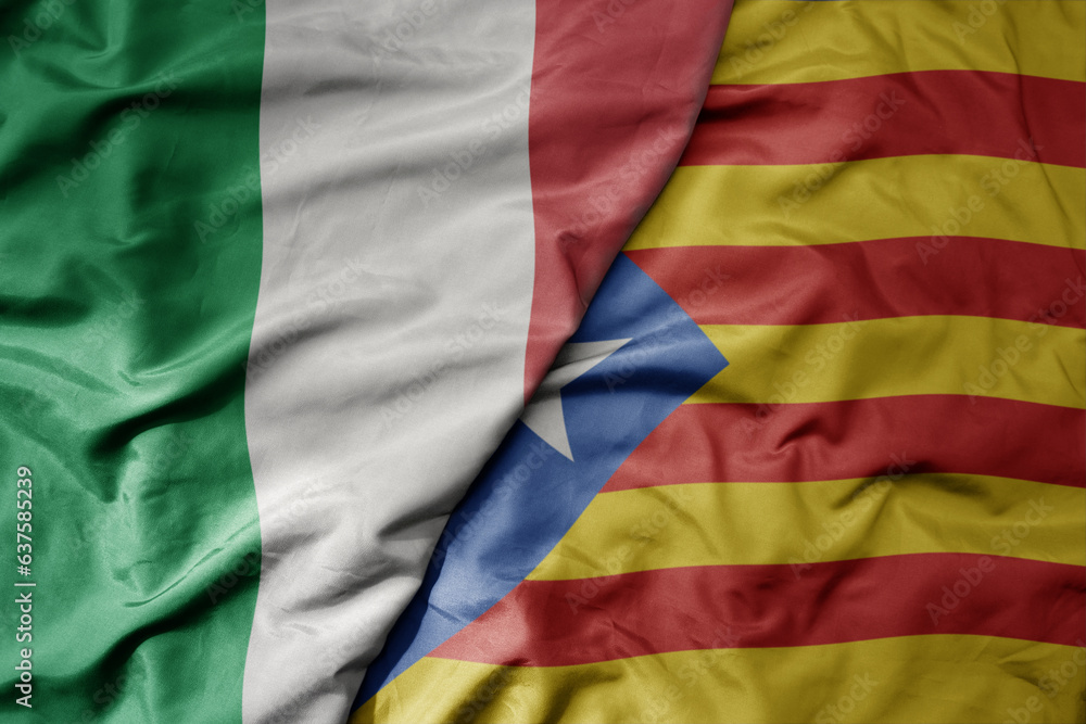 big waving national colorful flag of italy and national flag of catalonia .