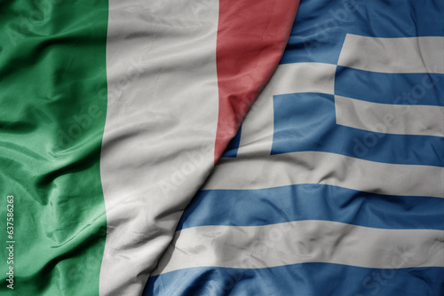 big waving national colorful flag of italy and national flag of greece .