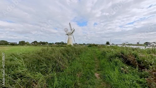Thurne Mill, a traditional drainage mill on the bank of the River Thurne in the Norfolk Broads National Park photo