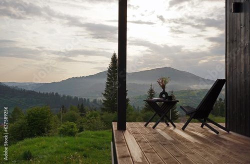 wooden outdoor furniture on terrace with mountain view