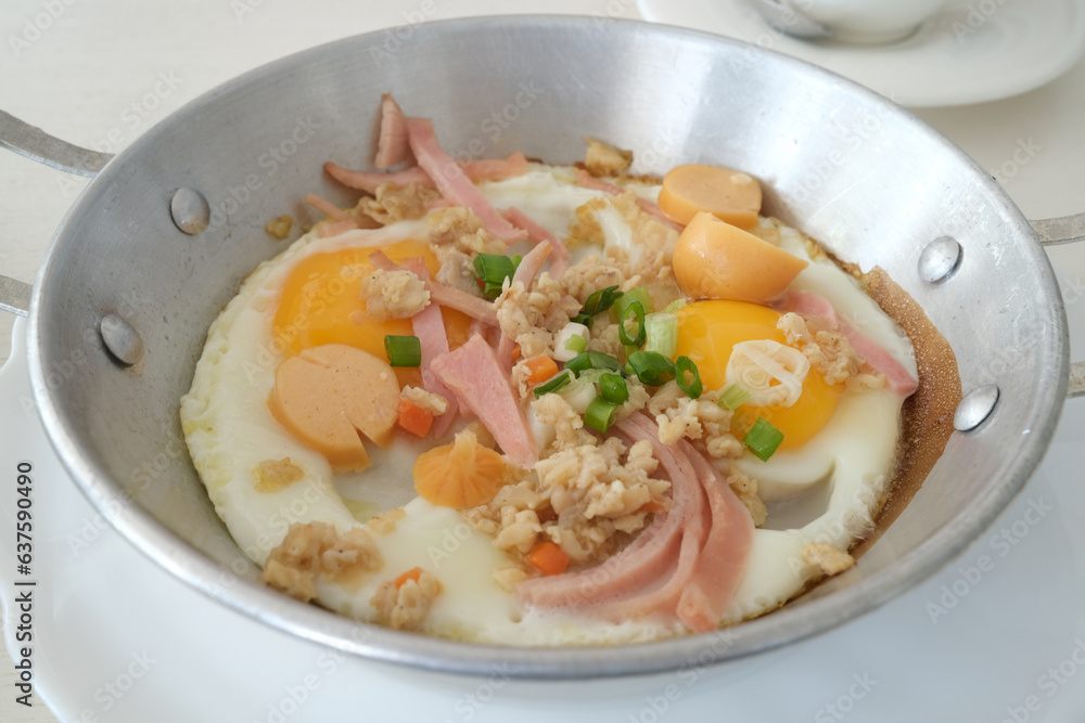 traditional Thai pan eggs called Kai Grata served on small stainless Steel hot plate