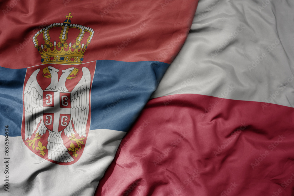 Obraz na płótnie big waving national colorful flag of serbia and national flag of poland . w salonie