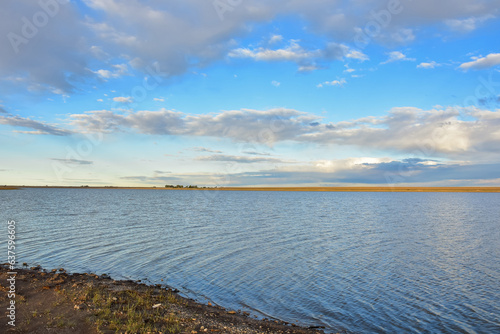 Field cloudy day over the lagoon