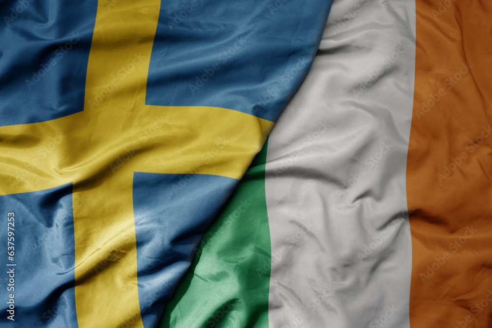 big waving national colorful flag of sweden and national flag of ireland . big waving national colorful flag of sweden and national flag of ireland .