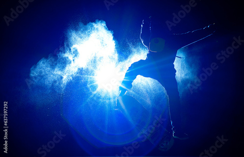 kickflip. person jumping on his skateboard. flash of light at night. jump of a man on his skateboard at night. water effect water particles.