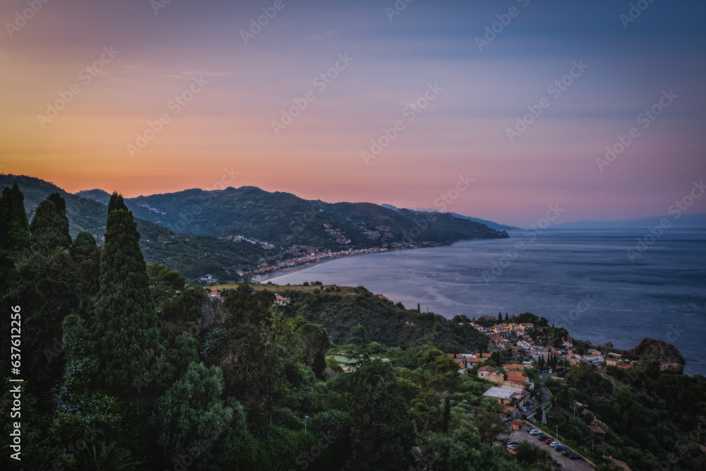 Taormina is a city on the island of Sicily, Italy. Top view in sunset time. June 2023