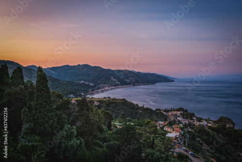 Taormina is a city on the island of Sicily, Italy. Top view in sunset time. June 2023