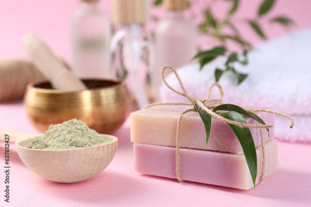 Retreat concept. Soap bars and spirulina powder on pink background