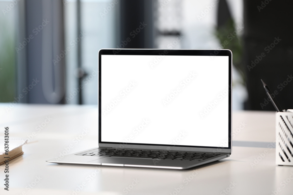 Modern laptop on white desk in office. Mockup for design Modern laptop on white desk in office. Mockup for design