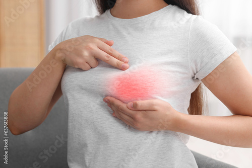 Woman doing breast self-examination at home, closeup photo