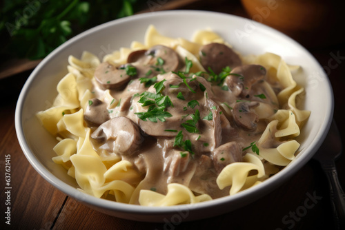 A white ceramic bowl holds a rich and creamy Beef Stroganoff, beautifully garnished with fresh parsley