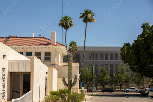 Yuma, Arizona, USA - May 27, 2022: Afternoon sun shines on a cactus and buildings of historic Downtown Yuma.