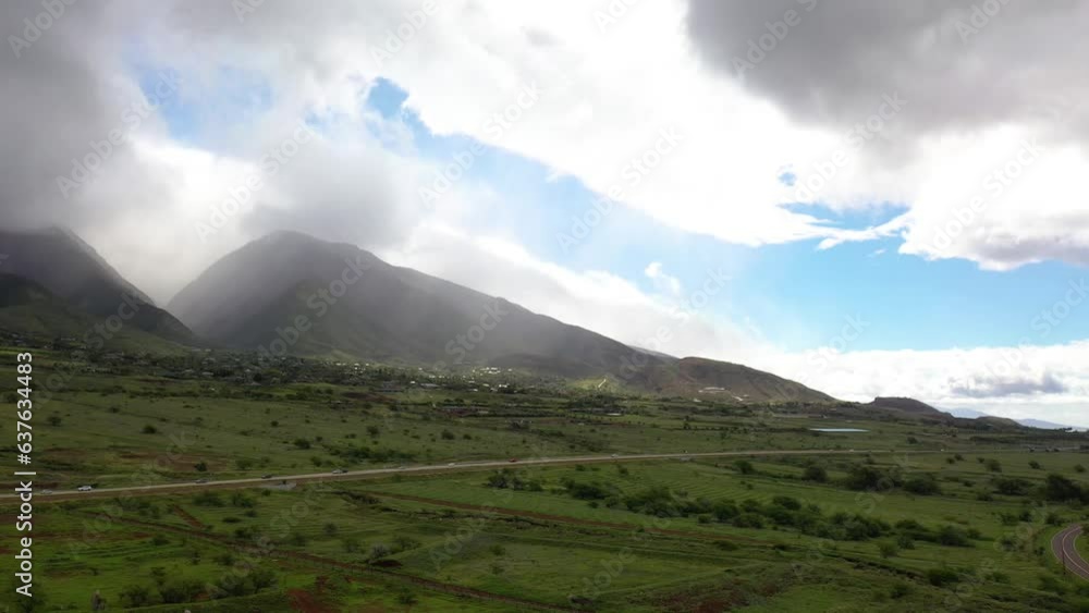 2023 - Excellent aerial timelapse of traffic on highway in Maui by a mountain. 2023 - Excellent aerial timelapse of traffic on highway in Maui by a mountain.