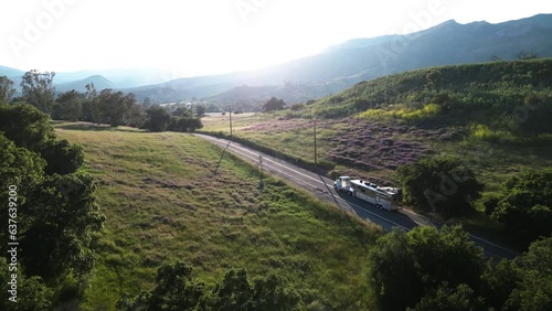 OJAI, CA - 2023 - Aerial of a horse trailer moving through the countryside on a rural road.