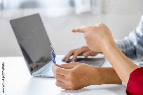 Young couple consumer hand holding mock up credit card, Ready to spend pay online shopping according to discount products via smartphone and laptop from home office