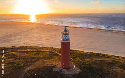 Texell lighthouse during sunset Netherlands Dutch Island Texel in summer with sand dunes at the Wadden Island. drone aerial view from above