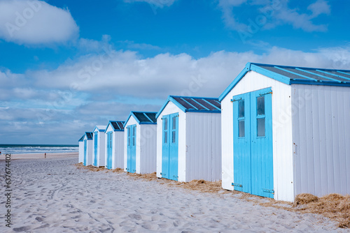Fotografie white blue beach house on the beach Texel Netherlands, a beach hut on the Dutch