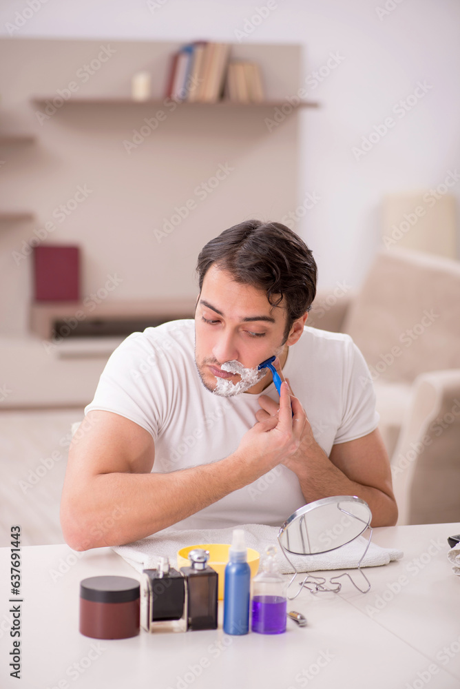 Obraz premium Young man shaving face at home