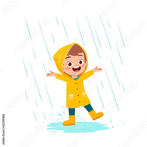 little kid wearing yellow rain coat in the rain and feel happy