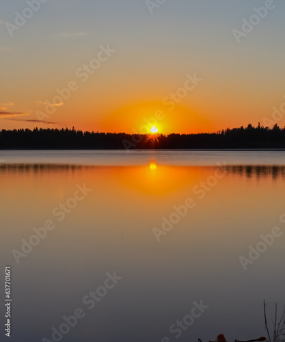 sunset at coast of the lake. Nature landscape. reflection, blue sky and yellow sunlight. landscape during sunset.