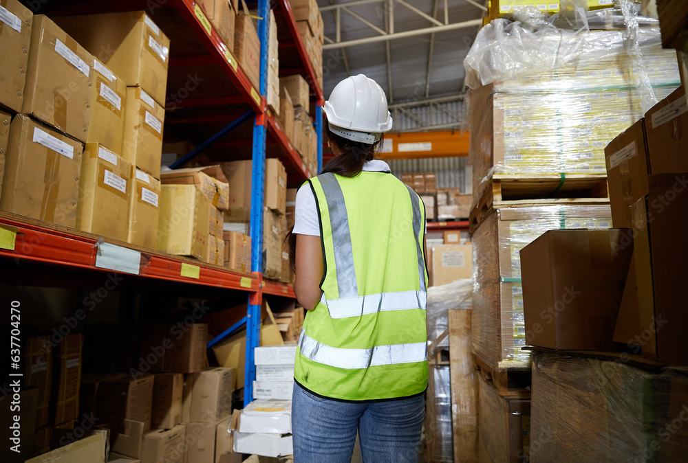 back view worker looking at cardboard box on shelf in warehouse storage back view worker looking at cardboard box on shelf in warehouse storage