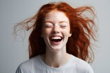Radiant Redhead: Confident and Cheerful Young Woman with a Joyful Smile in a Secluded Studio Portrait