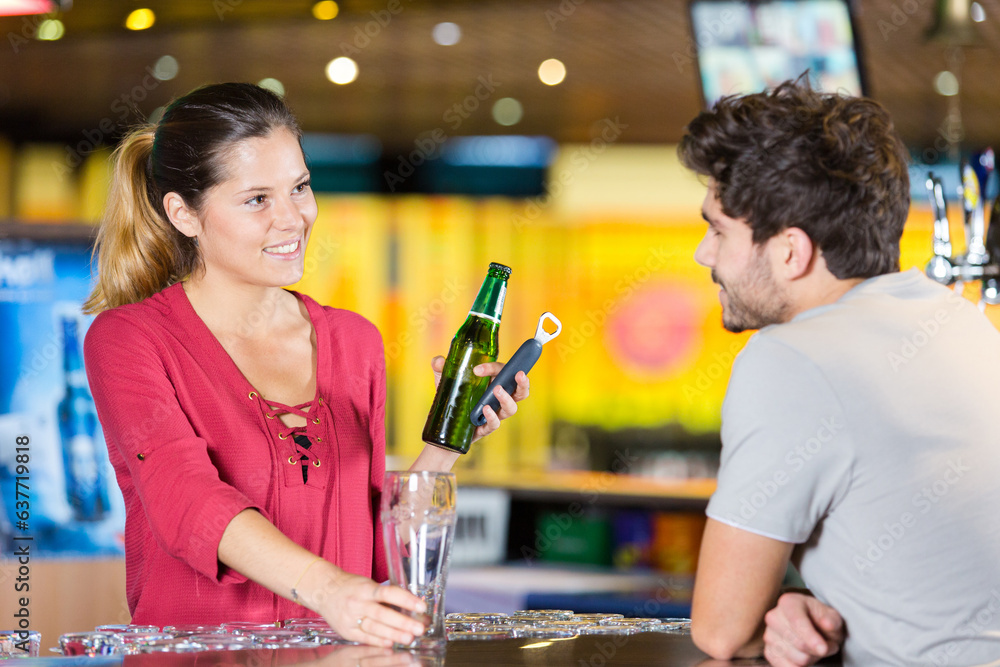 male customer and female bartender in a pub