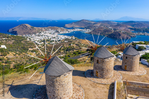 The three windmills of Chora and iconic Monastery of Saint John the Theologian in chora of Patmos island, Dodecanese, Greece photo
