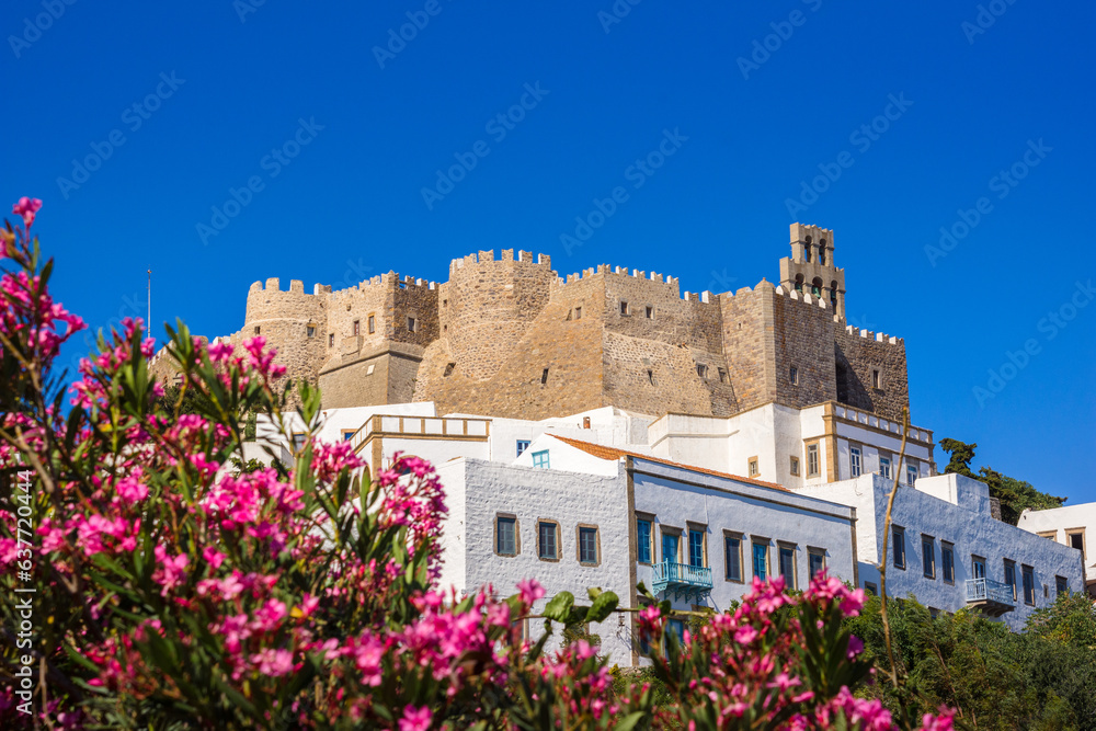 The three windmills of Chora and iconic Monastery of Saint John the Theologian in chora of Patmos island, Dodecanese, Greece