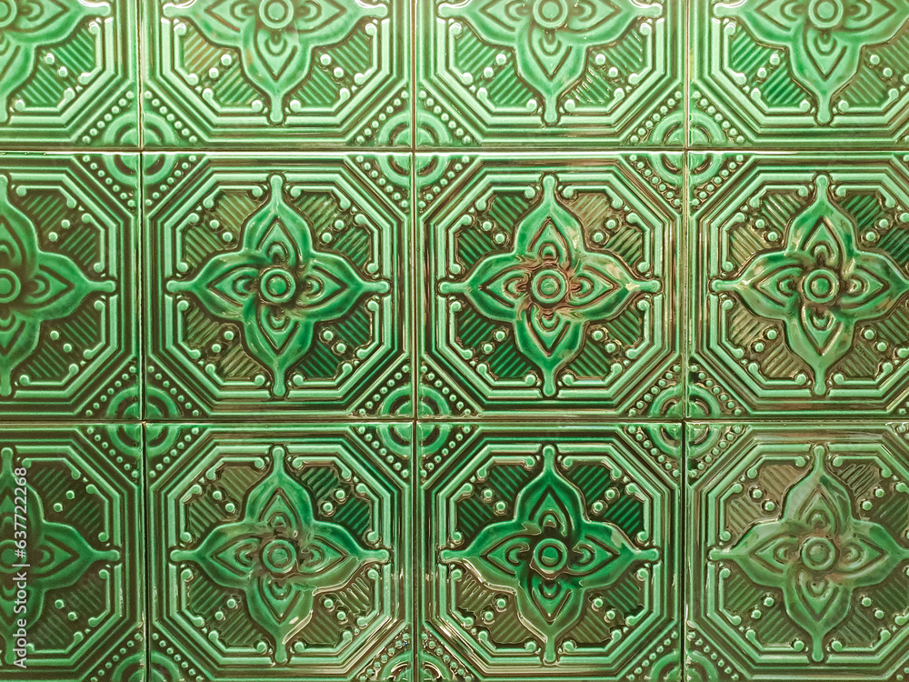 ceramic tile texture full frame. green geometric flower pattern on mosaic tiles, wall, background