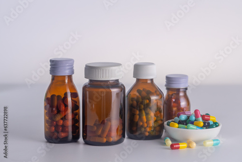  3 bottles of medicine without labels  with medicine cup on a white background