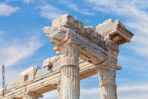 Temple of Apollo in Side (Turkey). Close up fragment of the entablature of the ruined temple. Stone-cut relief on the frieze. Scenic clouds as background. History, art or architecture concept photo