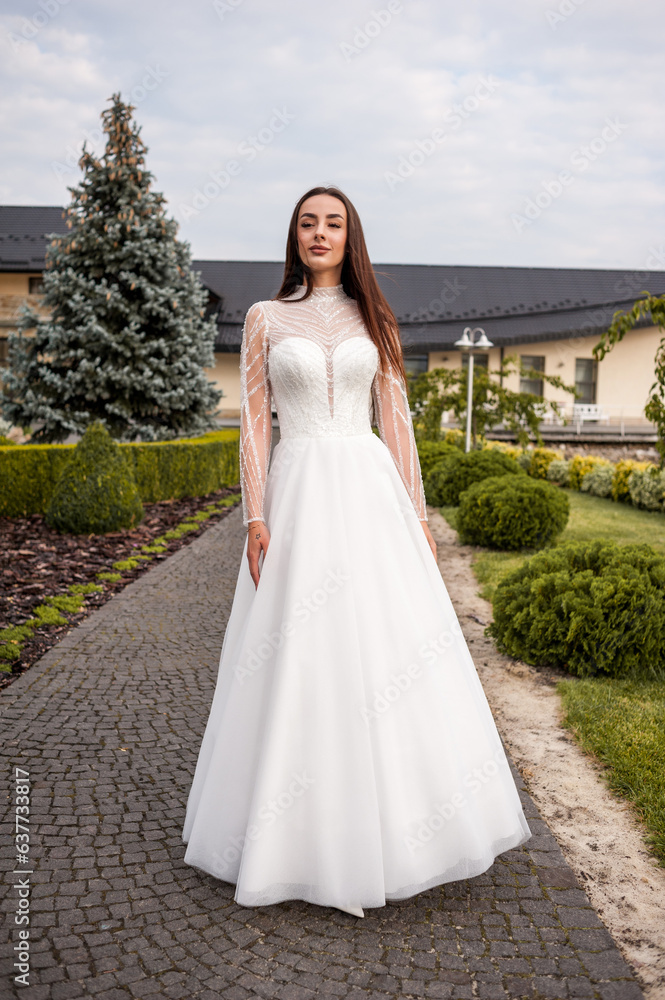 Fashion young bride in stylish wedding dress outdoor