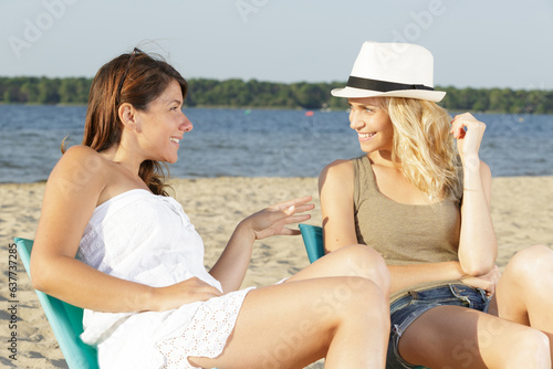two women against beautiful beach and blue sky