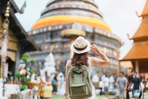 Photos Young asian woman traveler in white dress with hat and bag traveling in Wat Phra That Lampang Luang, Tourist visit at Lampang, Thailand