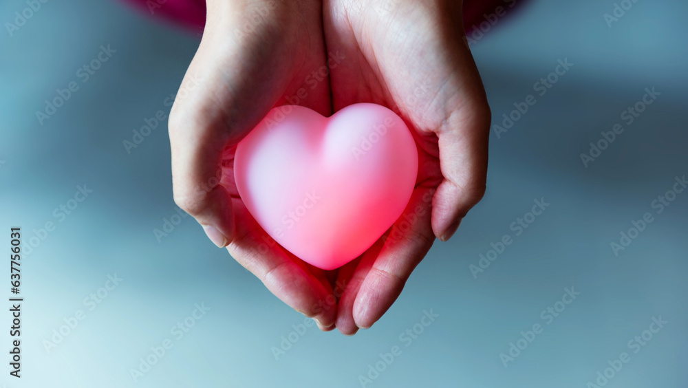 Human hand holding a red heart Human hand holding a red heart